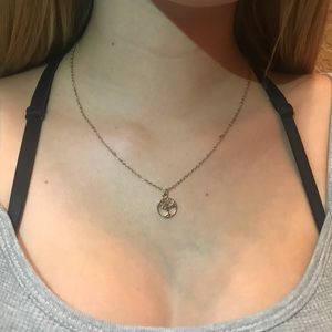 A gold chain with gold tree design